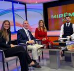 student posing on a news set 