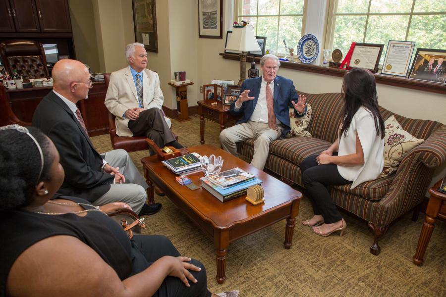 A group of people speaking around a table