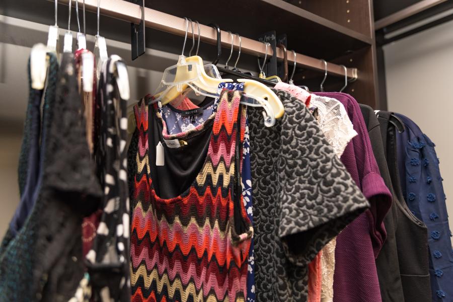 A photo of clothes in a closet