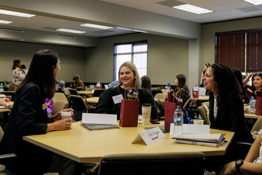 A group of people speaking at a table
