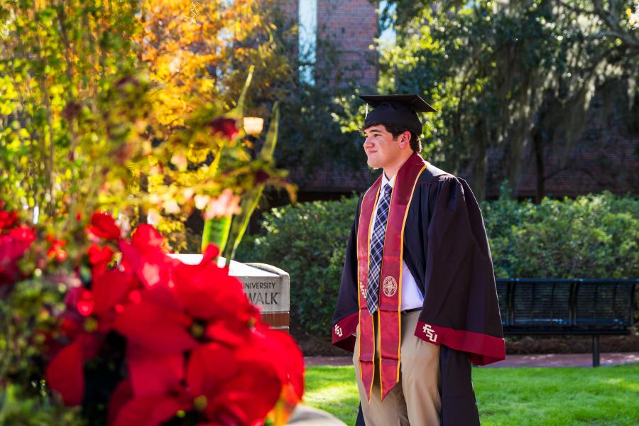 A graduate FSU smiling in accomplishment